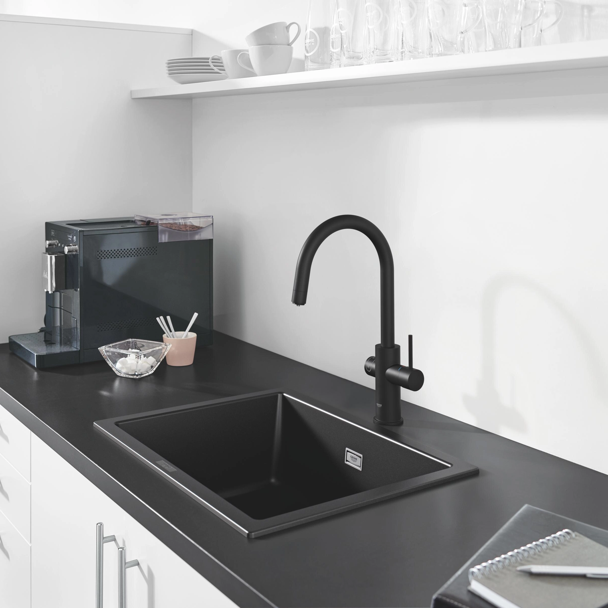 Bright open-plan villa kitchen with oak cabinetry, white island and carafe of water