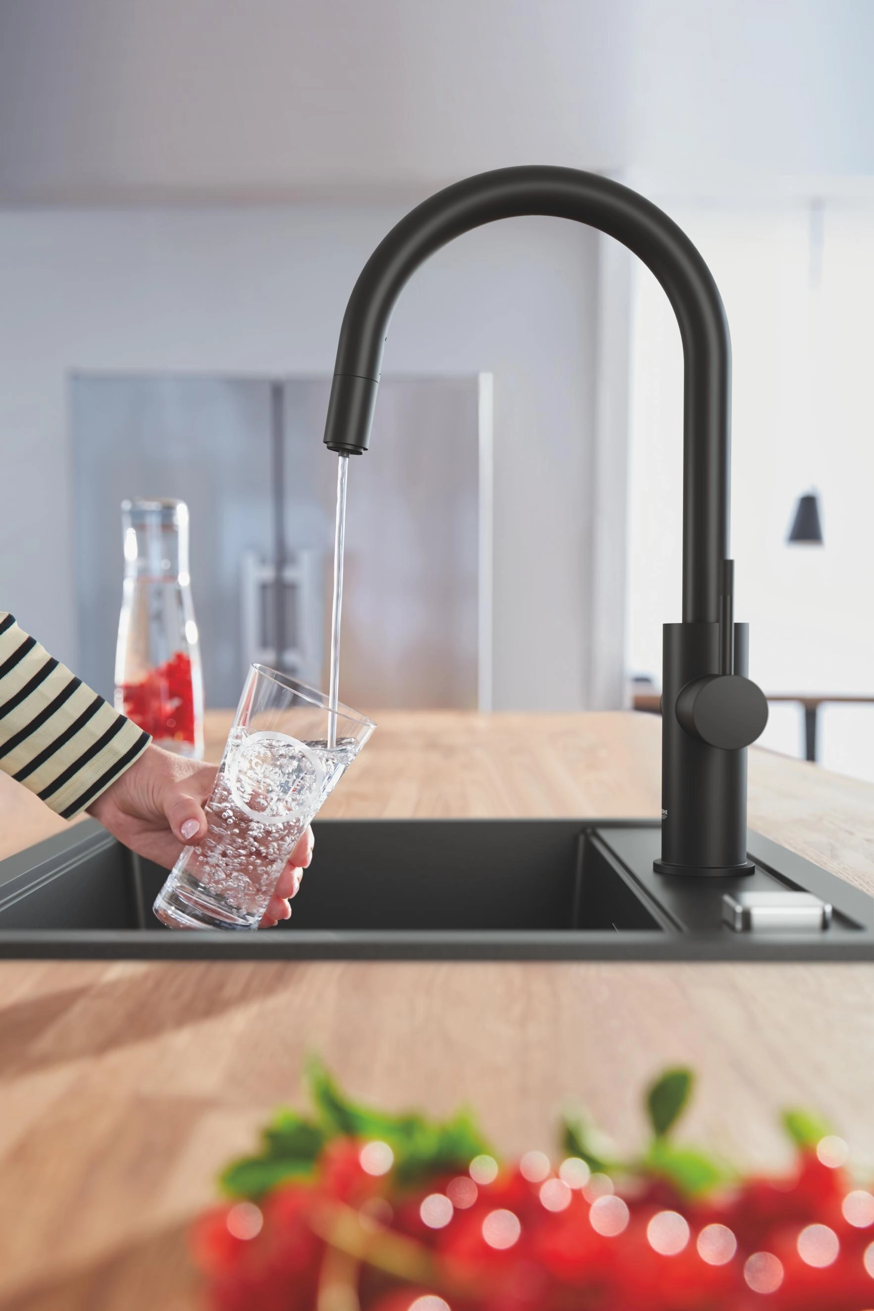 Filtered still water poured into a reusable glass carafe